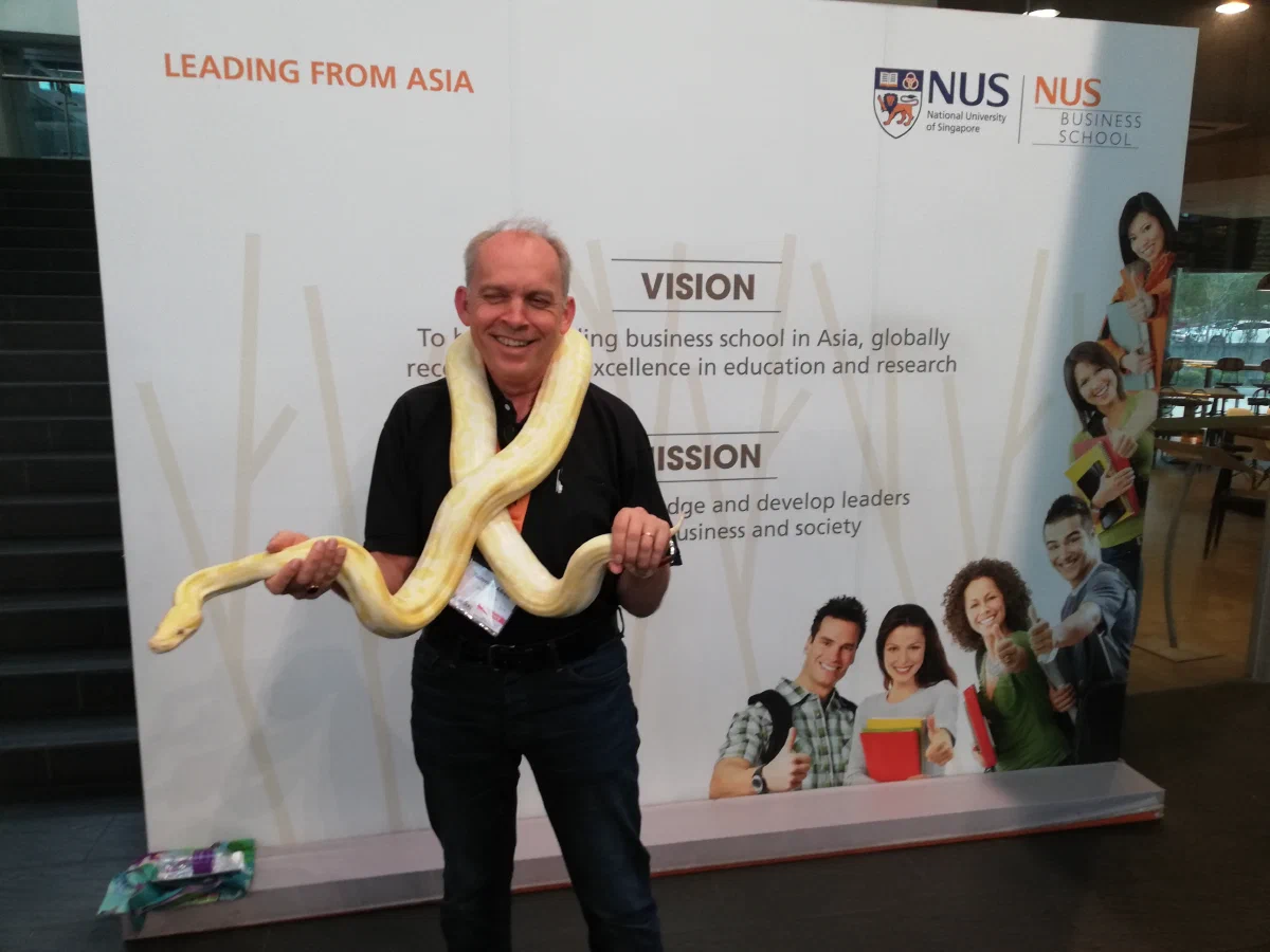 Holding a live albino snake